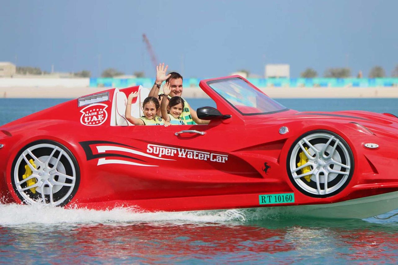 Red Super Water Car aerial top-down view with riders enjoying luxury water sports UAE