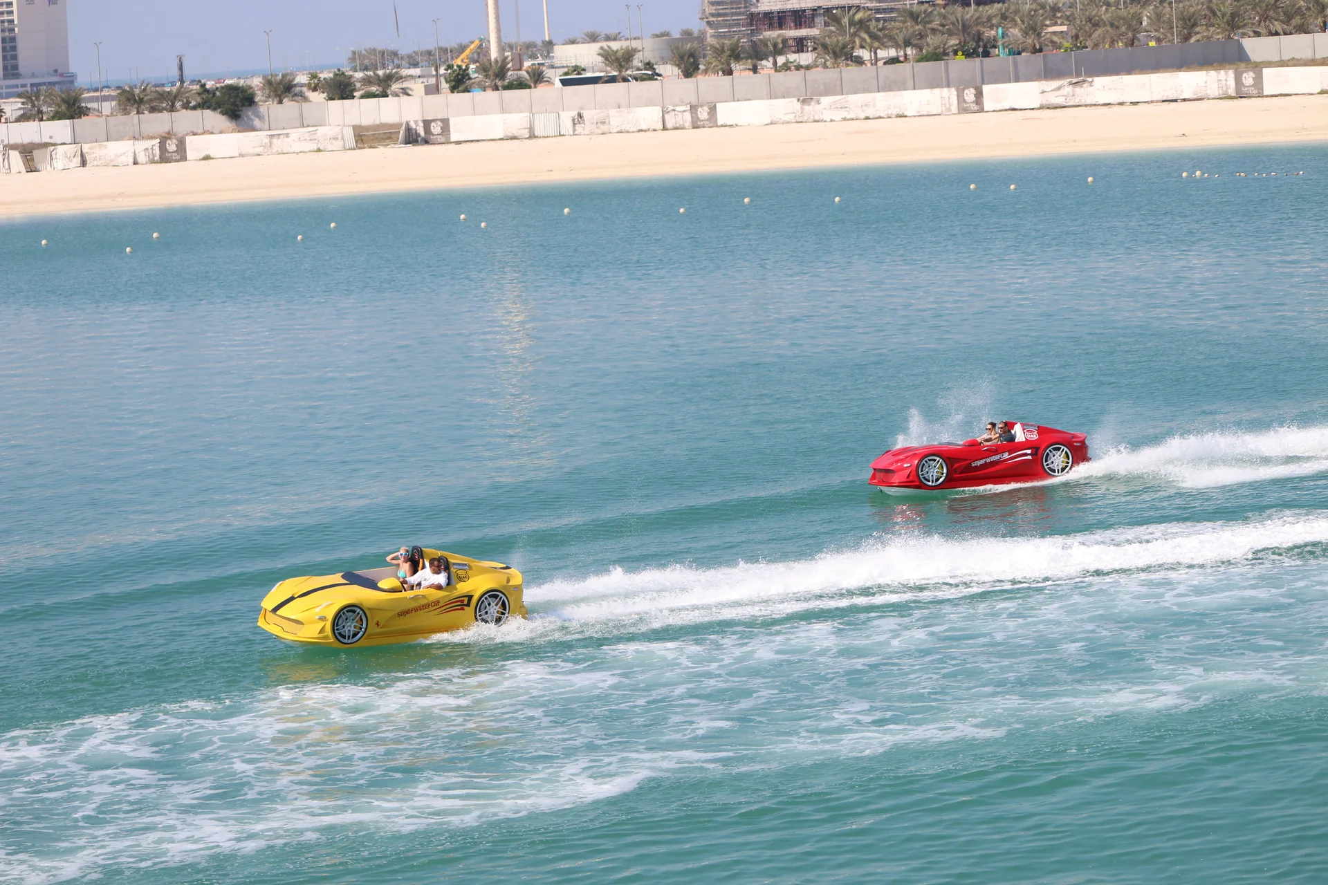 Yellow and red Super Water Car jet car watercraft riding side by side across UAE waters