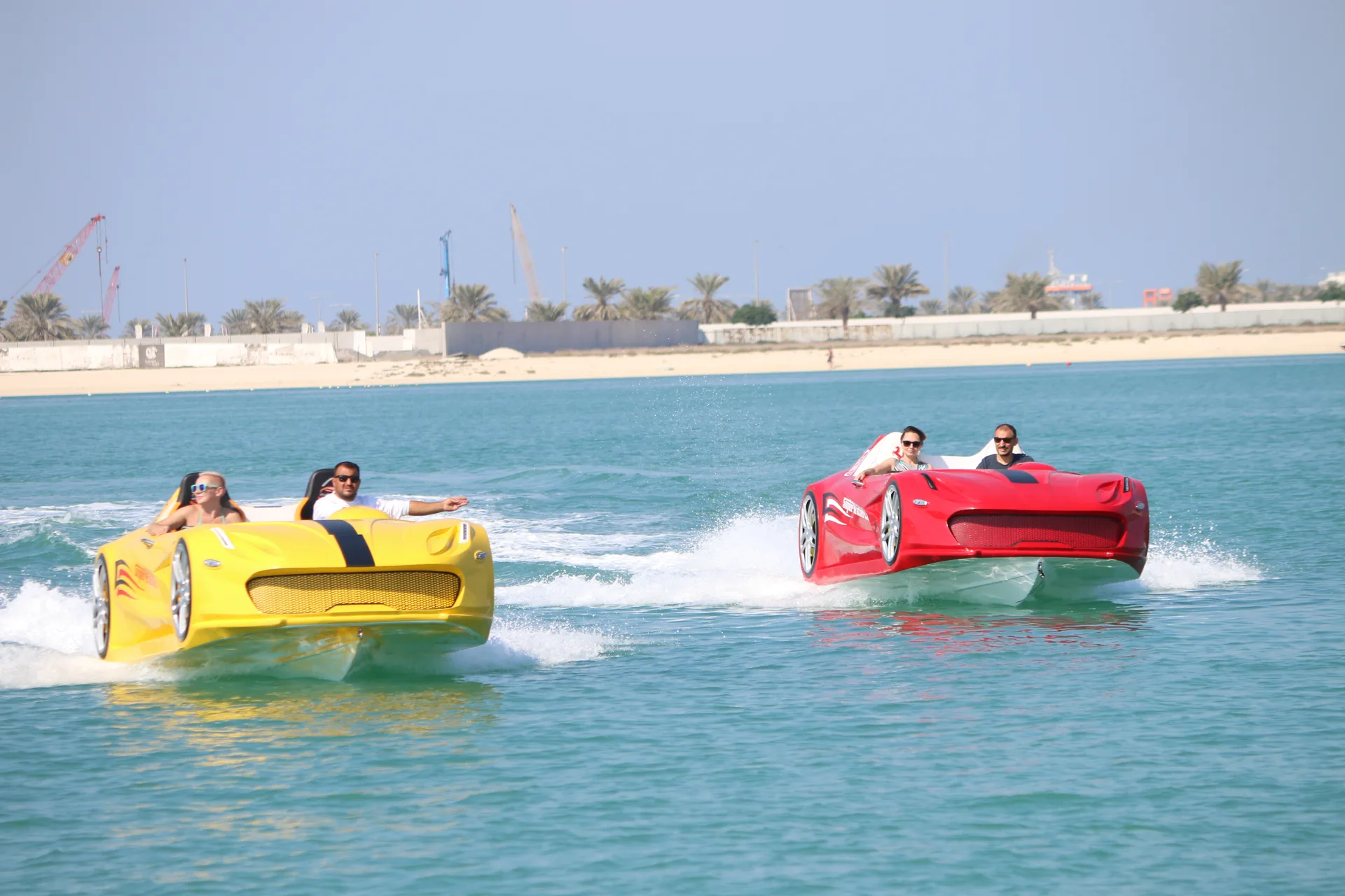 Two Super Water Cars riding across turquoise water